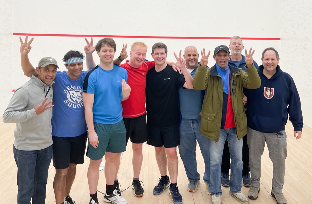 Group photo of nine male members celebrating a team victory at Pickering Squash Club.
