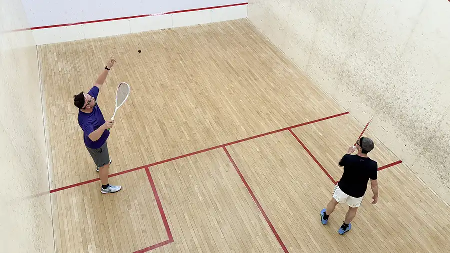 Overhead shot of two players competing hard in a squash game at Pickering Squash Club.