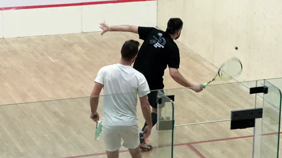 Two players rally during a squash tournament at Pickering Squash Club, Durham Region.