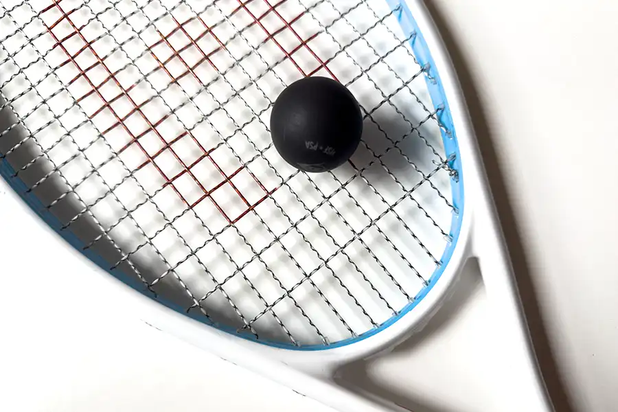 Close-up of a squash racquet and ball, used to learn the game for beginners at Pickering Squash Club.